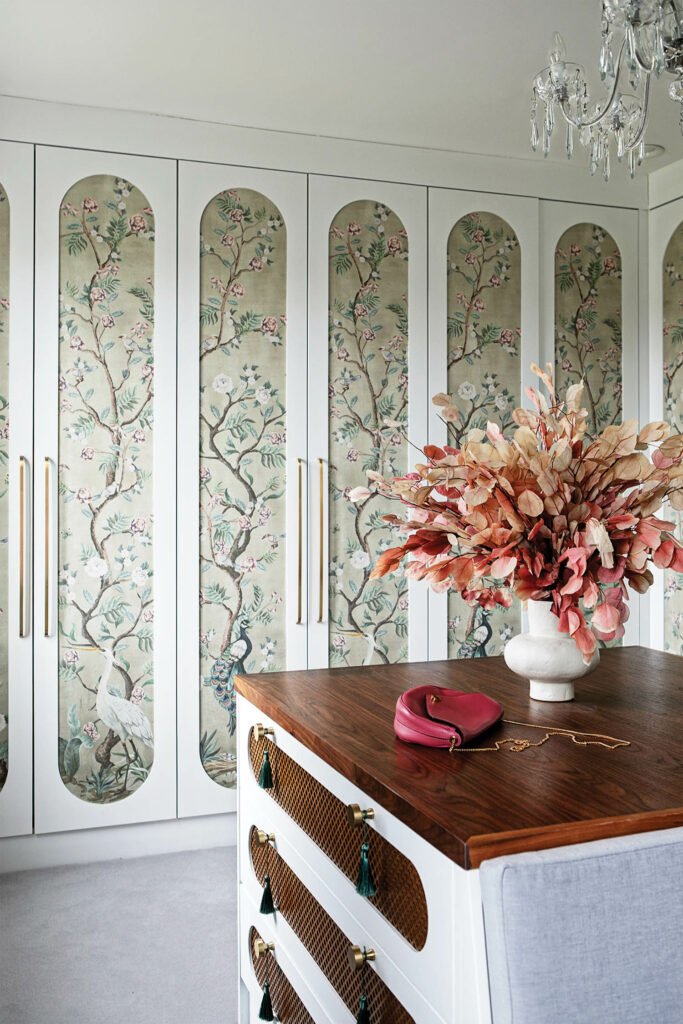 floral wallpaper on the doors of a closet in this bedroom's dressing room