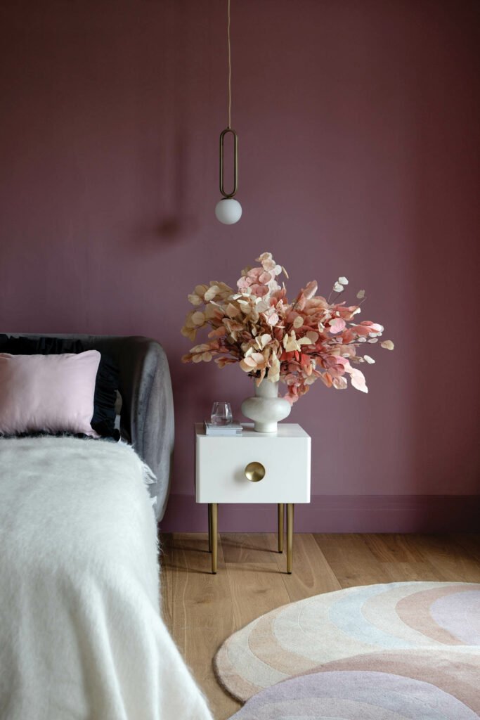 a guest bedroom with rose-colored walls 