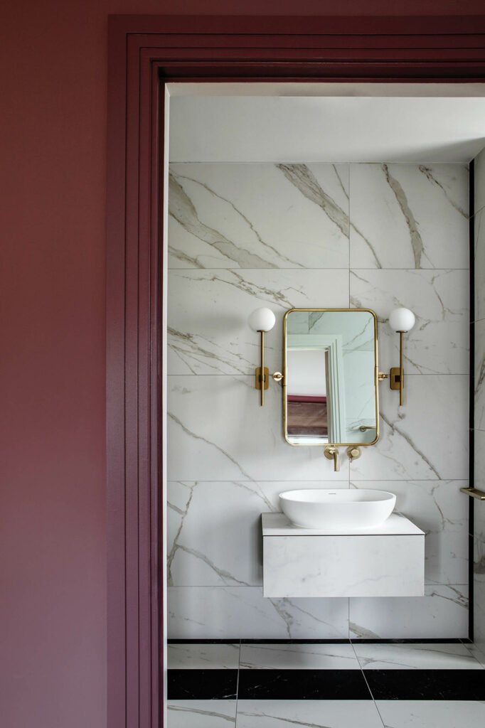 a guest room bath with marble walls