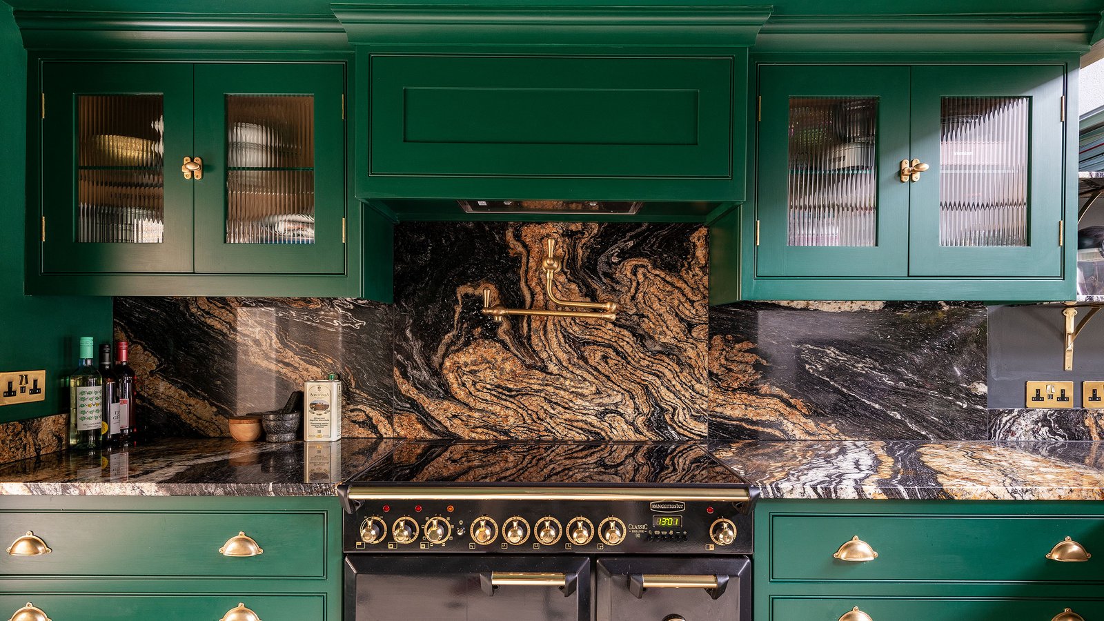 green kitchen with marble worktops