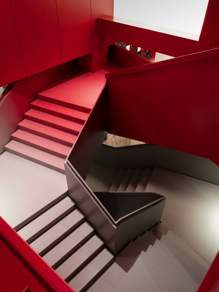 a staircase in a gradient of red and gray