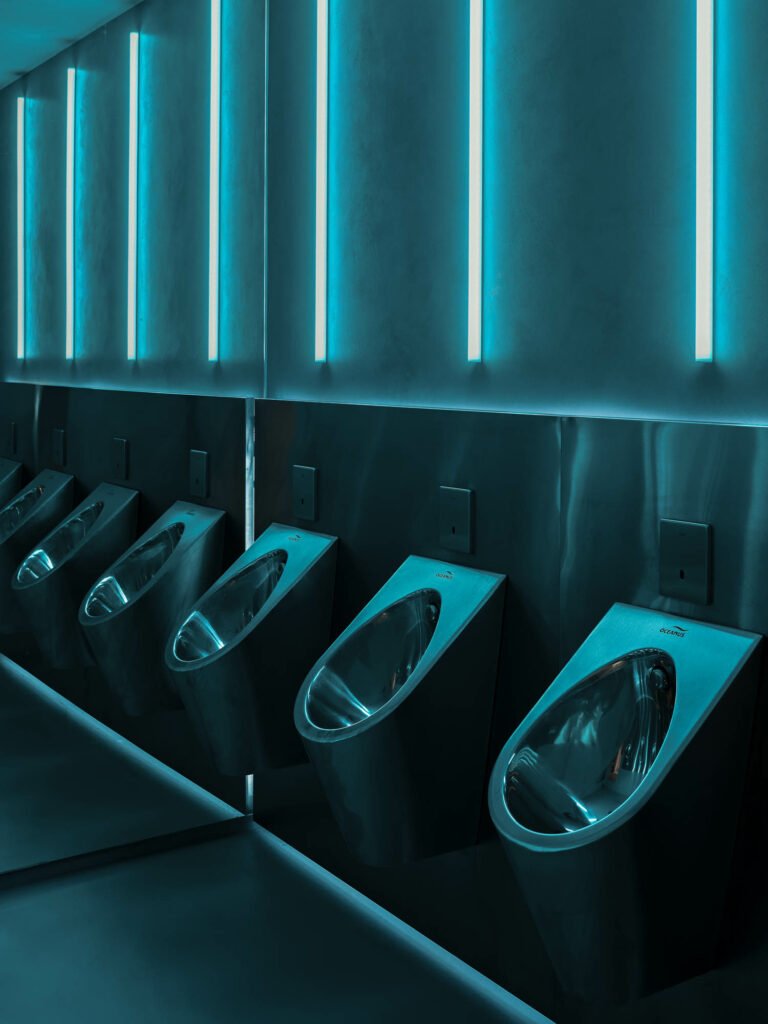 a theater bathroom lit with blue LEDs