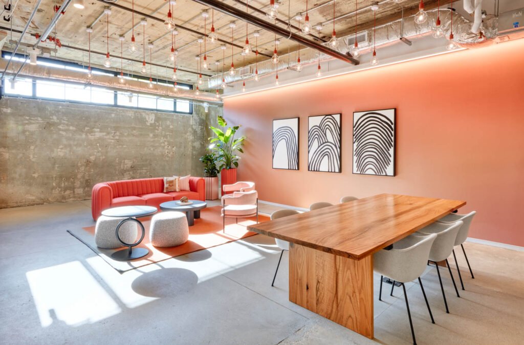 a communal workspace with peach tone walls