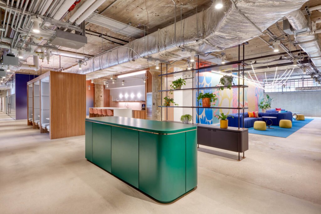 a green reception desk near a planter