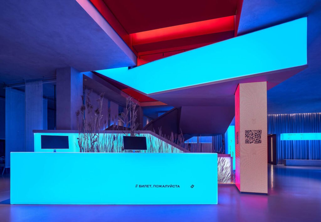 various hues of blue and red light up the ticket desk at this theater