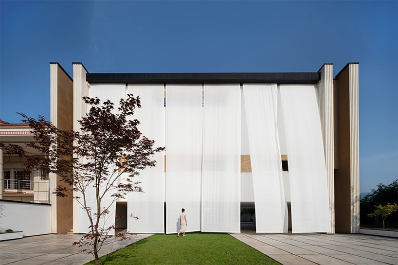 long white curtains cover samon villa's entire open facade in northern iran