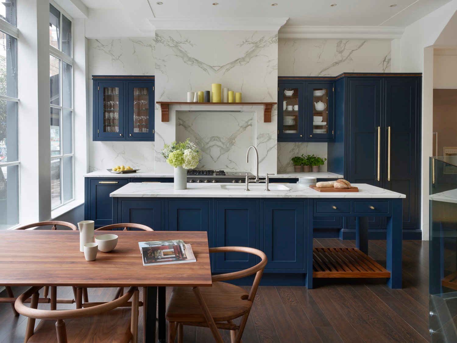 dark blue kitchen with white worktops in open plan space