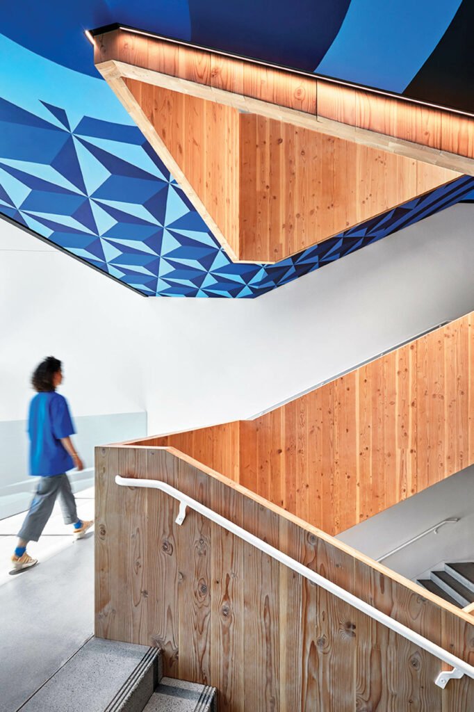 a woman walks up a wooden stairway