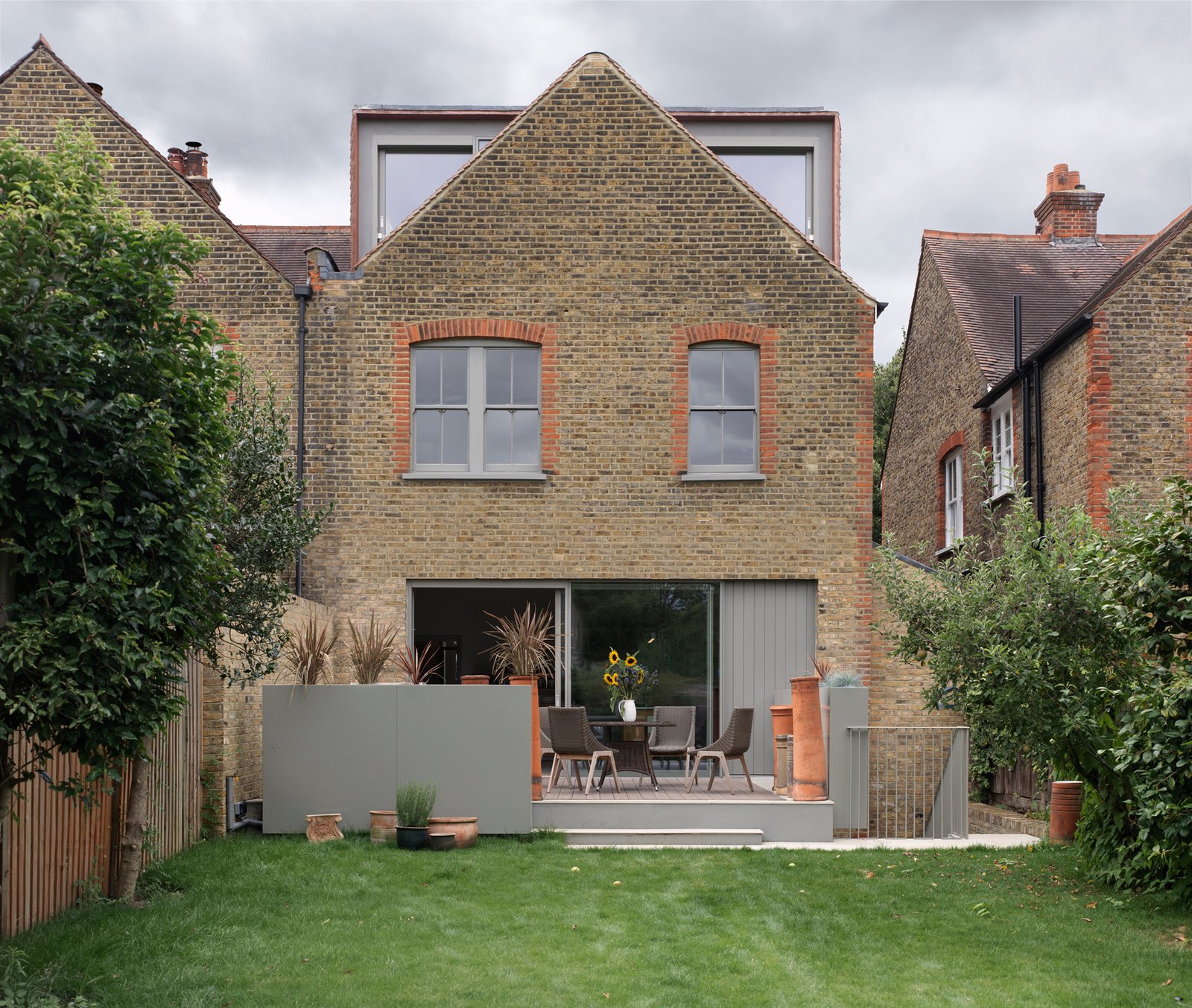 a loft conversion built behind a house's brick gable