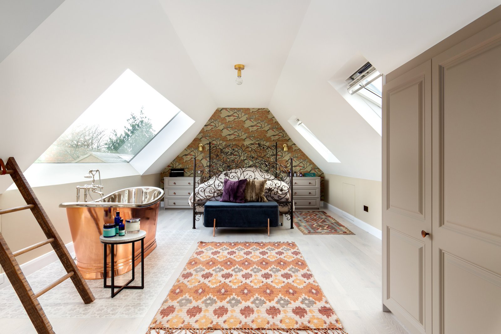 a loft conversion bedroom with a freestanding bath