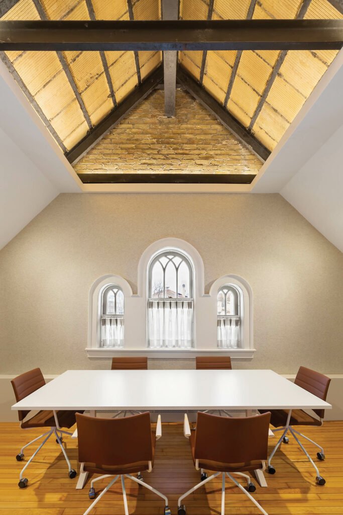 Meeting room and flexible space in older museum with original vaulted ceiling and supports visible