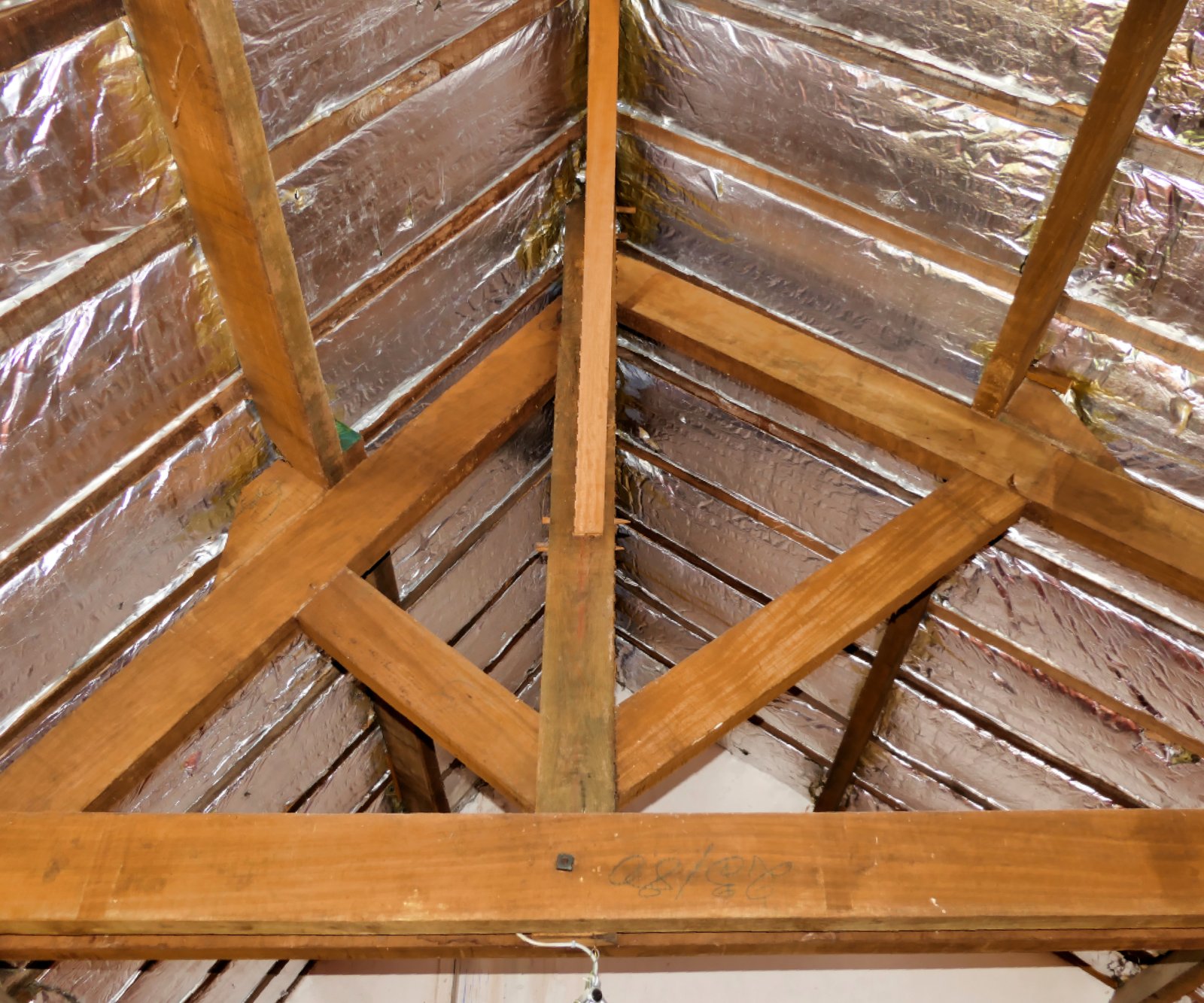 image of insulation installed in between roof trusses