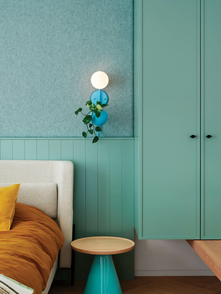 corner of bedroom with teal walls and closet