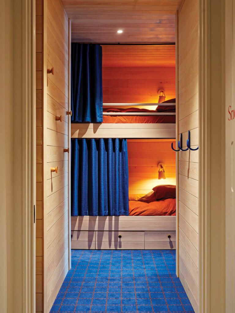 bunk bed room with blue drapes and carpet