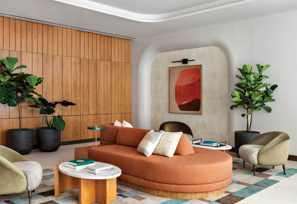 living room with orange seating area and wooden paneled wall