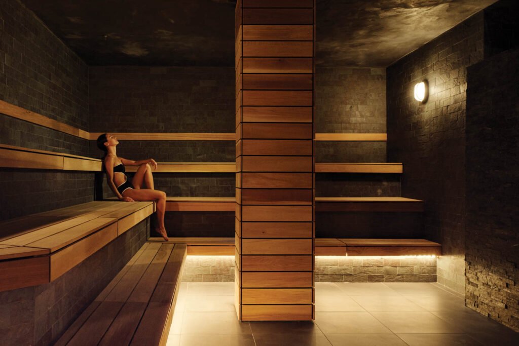 interior of one of the spa rooms with wooden columns and stone walls