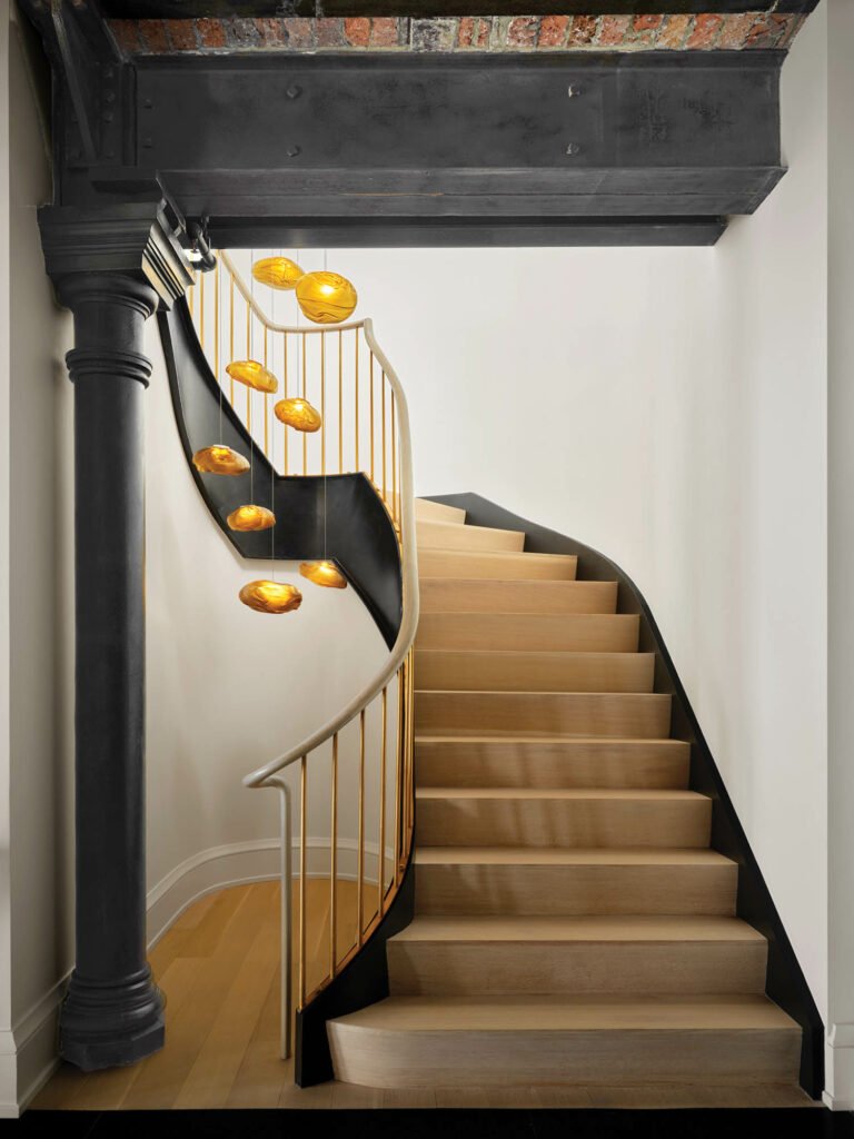 stairwell with a smoked-glass chandelier