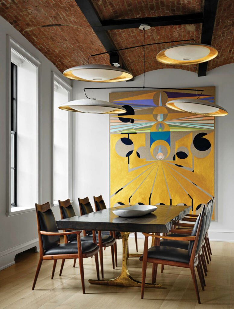 dining room with bright yellow artwork