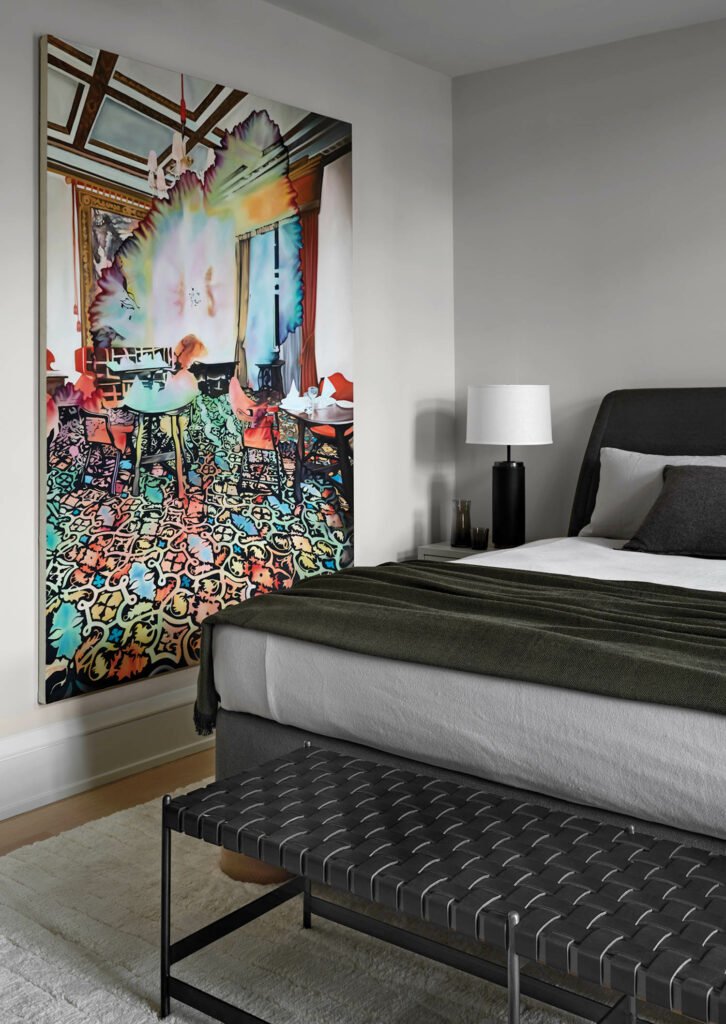 guest bedroom with colorful painting on the wall